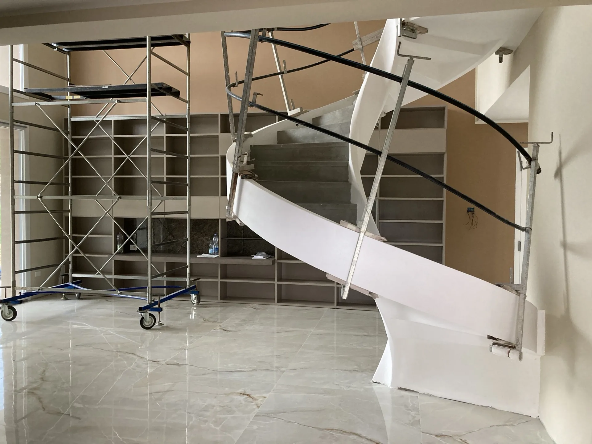 Villa interior during construction — staircase installation in progress